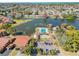 Aerial view of the neighborhood highlighting the community pool, pond, and landscaping at 3833 Lighthouse Way, New Port Richey, FL 34652