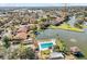 Aerial view of community, pool, clubhouse, and water feature at 3833 Lighthouse Way, New Port Richey, FL 34652