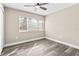 Bright bedroom with large window and wood-look floors at 3833 Lighthouse Way, New Port Richey, FL 34652