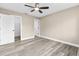 Well-lit bedroom with wood-look floors and ample closet space at 3833 Lighthouse Way, New Port Richey, FL 34652