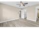 Spacious bedroom featuring wood-look floors and ceiling fan at 3833 Lighthouse Way, New Port Richey, FL 34652