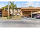 Condo building with carport and tropical landscaping at 3833 Lighthouse Way, New Port Richey, FL 34652