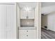 Hallway cabinet with granite countertop and all-white doors and drawers at 3833 Lighthouse Way, New Port Richey, FL 34652