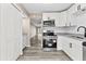 Updated kitchen featuring stainless steel appliances and granite countertops at 3833 Lighthouse Way, New Port Richey, FL 34652