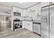 Modern kitchen with stainless steel appliances and white shaker cabinets at 3833 Lighthouse Way, New Port Richey, FL 34652