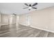 Open living room with wood-look floors and ceiling fans at 3833 Lighthouse Way, New Port Richey, FL 34652