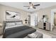 Main bedroom with large bed, dresser, and ensuite bathroom at 3833 Lighthouse Way, New Port Richey, FL 34652