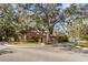 Entrance to Beacon Lakes, with mature trees and lush landscaping at 3833 Lighthouse Way, New Port Richey, FL 34652