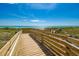 Wooden boardwalk leads to beach at 391 Airport E Ave # 403, Venice, FL 34285