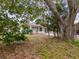 Large backyard with mature trees and house view at 4228 Spring Way Cir, Valrico, FL 33596