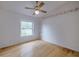 Simple bedroom with wood flooring, ceiling fan, and window at 4228 Spring Way Cir, Valrico, FL 33596