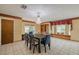 Formal dining room with a large table, built-in shelving, and window seat at 4228 Spring Way Cir, Valrico, FL 33596