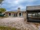 Rear house view, showcasing patio, solar panels, and pool at 4228 Spring Way Cir, Valrico, FL 33596