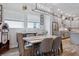 Dining area with a marble table, modern light fixture and kitchen views at 4449 Tour Trce, Land O Lakes, FL 34638