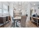 Open concept dining room with gray chairs and marble table at 4449 Tour Trce, Land O Lakes, FL 34638