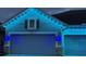 Two-car garage with stylish exterior lighting at 4449 Tour Trce, Land O Lakes, FL 34638