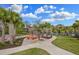 Relaxing fire pit area with seating and palm trees at 4449 Tour Trce, Land O Lakes, FL 34638