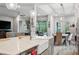 Spacious kitchen island with white farmhouse sink, quartz countertops, and modern appliances at 4449 Tour Trce, Land O Lakes, FL 34638