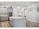 Modern kitchen with gray cabinets, island, and farmhouse sink at 4449 Tour Trce, Land O Lakes, FL 34638