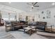 Relaxing living room with sectional leather couch, coffee table, and wood flooring at 4449 Tour Trce, Land O Lakes, FL 34638