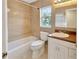 Clean bathroom with tile shower, vanity, and window at 4845 W Sunset Blvd, Tampa, FL 33629