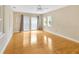 Bright bedroom featuring hardwood floors and multiple windows at 4845 W Sunset Blvd, Tampa, FL 33629