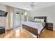 Main bedroom with hardwood floors and private access to balcony at 4845 W Sunset Blvd, Tampa, FL 33629