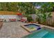 Private pool and spa with brick patio and lush landscaping at 4845 W Sunset Blvd, Tampa, FL 33629