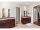 Double vanity bathroom with granite countertops and dark wood cabinets at 530 Ponce De Leon Blvd, Belleair, FL 33756