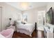 Bright bedroom with hardwood floors and a view of the bathroom at 530 Ponce De Leon Blvd, Belleair, FL 33756