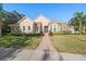 Beautiful two-story home with a brick facade and lush landscaping at 530 Ponce De Leon Blvd, Belleair, FL 33756