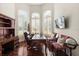 Bright home office features built-in shelving, hardwood floors, and plantation shutters at 530 Ponce De Leon Blvd, Belleair, FL 33756