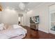 Main bedroom with hardwood floors, large windows, and a view of the bathroom at 530 Ponce De Leon Blvd, Belleair, FL 33756