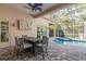 Inviting pool area with patio furniture, hot tub, and screened enclosure at 530 Ponce De Leon Blvd, Belleair, FL 33756