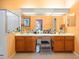 Double vanity bathroom with light wood cabinets at 5537 Terrain De Golf Dr, Lutz, FL 33558