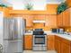 Stainless steel appliances and wood cabinetry in this well-lit kitchen at 5537 Terrain De Golf Dr, Lutz, FL 33558