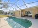 Relaxing kidney-shaped pool with patio furniture at 5537 Terrain De Golf Dr, Lutz, FL 33558