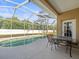 Relaxing pool area with patio furniture under a screened enclosure at 5537 Terrain De Golf Dr, Lutz, FL 33558