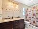 Elegant bathroom with double sinks, granite countertop, and dark wood cabinets at 5649 Glencrest Blvd, Tampa, FL 33625