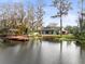 Serene lake view of the property and dock from across the water at 5649 Glencrest Blvd, Tampa, FL 33625