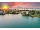 Stunning sunset aerial view of waterfront condo building and private dock at 5700 Escondida S Blvd # 302, St Petersburg, FL 33715