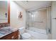 Bathroom with tub shower combo, granite vanity, and art at 5700 Escondida S Blvd # 302, St Petersburg, FL 33715