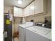 Laundry room with washer, dryer, and storage cabinets at 5700 Escondida S Blvd # 302, St Petersburg, FL 33715