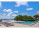 Inviting pool area with lounge chairs and a spa, offering scenic waterfront views at 5700 Escondida S Blvd # 302, St Petersburg, FL 33715