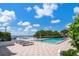 Inviting outdoor swimming pool with lounge chairs and bay view at 5700 Escondida S Blvd # 302, St Petersburg, FL 33715