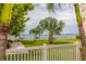 Scenic waterfront lawn with picnic tables and palm trees at 6020 Shore S Blvd # 411, Gulfport, FL 33707