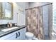 Clean bathroom with shower, tile surround, and granite vanity at 6120 Watercolor Dr, Lithia, FL 33547