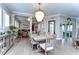 Bright dining room features a rustic wood table and chandelier at 6120 Watercolor Dr, Lithia, FL 33547