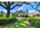 House exterior showcasing landscaping and large tree at 6120 Watercolor Dr, Lithia, FL 33547