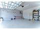 Organized garage with epoxy floor, wall storage, and overhead door at 6120 Watercolor Dr, Lithia, FL 33547